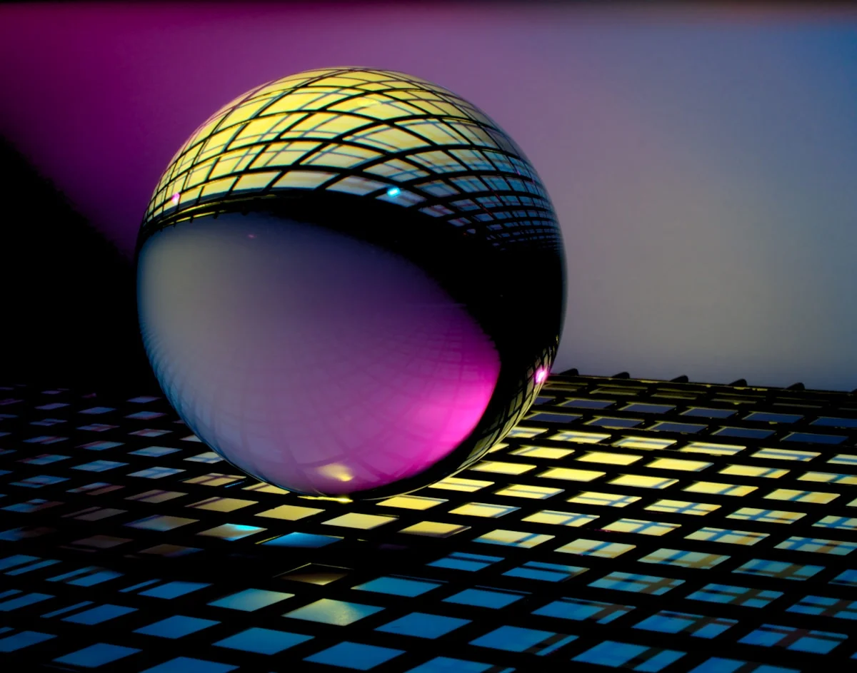 A glass orb refracting light into ordered patterns.