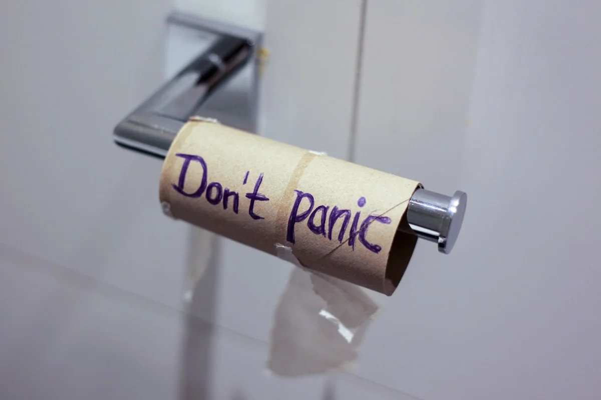 A cardboard tube printed with the words DON'T PANIC.