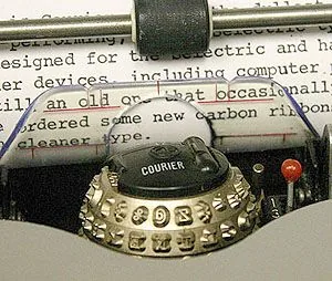 An IBM Selectric typewriter, its type ball in close view.